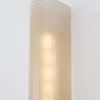 Somersville Wall Sconce with etched light bronze glass and sleek metalwork in a bullnose shape emitting warm light