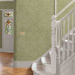 Salix Leaves Wallpaper installed on walls beside white staircase with wood floor and stained glass door