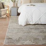 Rug under bed showing edge detail and contrast with wooden floor and white bedding