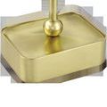 Close-up of lamp’s rectangular brass base with curved edges and a spherical accent at the stem connection