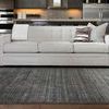 Straight on view of Barkley Charcoal Rug with checked pattern sofa in contemporary open living space