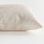 Side profile of pillow showcasing the seam and rounded edge detail of the fabric