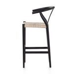 Three-quarter side angle showing black teak frame’s unique angled supports