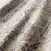 Close-up fabric texture of the rug showing fiber detail, folds, and distressed traditional plum and blue patterning