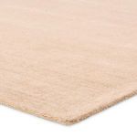 Close-up showing low profile cut and loop pile texture and cream-beige color variation