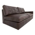 Close-up angle showing tufted back cushions and smooth leather texture on seat and arm
