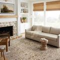 Sorrento Bark rug styled in living room with beige sofa, fireplace, natural light, and neutral decor