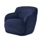 Stevie Lounge Chair three-quarter angle showing curved armrests and seat depth in navy blue fabric