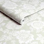 Close-up of Rachel Ashwill Stipple wallpaper rolled showing paper texture and floral print