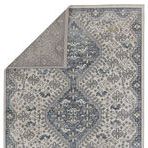 Top view of the rug partially folded to show back side pattern and edge finishing