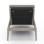 Clean-lined outdoor chaise with backrest lowered flush, emphasizing neutral toned fabric cushions
