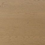 Close-up of weathered oak veneer wood grain texture on table surface.