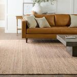 Rosier rug styled under cognac leather sofa with neutral pillows and coffee table