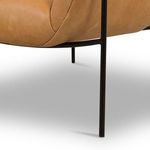 Close view of black metal leg supporting the chair at the corner