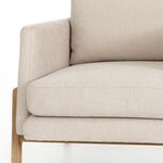 Close-up of armrest and cushion showing fabric weave and tailored stitching details