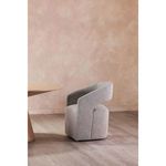 Barrow chair positioned next to table with light wood floor and peach colored wall
