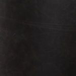 Close-up texture of dark black leather upholstery on dining chair