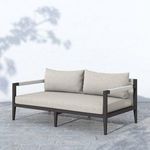 Sherwood sofa shown outdoors on stone patio with sunlight and shadows emphasizing cushions