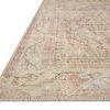 Low angle side view showing detailed border and flat weave texture of apricot and beige patterned rug