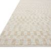 Close-up angled view showing low pile texture and edge binding of Kamala ivory and natural rug