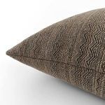 side angle close-up showing the pillow's chevron texture and fabric weave detail