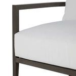 Side shot focusing on seat cushion edges and angular armrest structure in slate gray