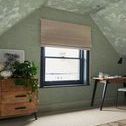 Wallpaper installed in attic room with sloped ceiling, window, wooden dresser, and desk