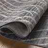 Close-up of Wade rug folded back showing underside weave and rug thickness