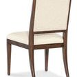Upholstered chair shown from back right angle highlighting fabric on backrest and wood frame curve