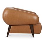 Side profile of Devlin lounge chair emphasizing curved arm shape and wood leg texture