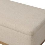 Close-up of trunk corner showing rounded fabric edges and oak base