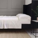 Ivory Classico Hemstitch cotton sateen pillowcase on king bed with matching sheets in modern bedroom