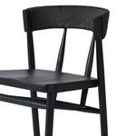 Close-up of the paper rush woven texture on the backrest of the black Buxton Drifted Oak Bar Stool
