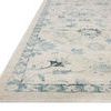 Low angled side view showing Marcella rug's hand-loomed texture and subtle blue border detail