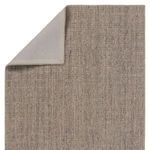 Top corner of Vidalia rug folded to reveal solid taupe fabric backing