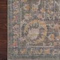 Close-up of corner edge detail with muted border colors and floral motifs on Rosemarie stone rug
