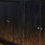 close-up back panel with round cable access hole in dark brown wood grain
