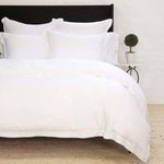 Sheena Bamboo Sateen Euro Sham styled on bed with pillows, bedspread, and minimalist bedroom setting