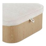 Close-up of ottoman corner highlighting oatmeal fabric texture and wood grain with pull tab
