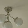 Bottom-front angle highlighting the curved metal arms supporting frosted glass globes