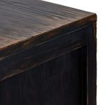 close-up focus on distressed finish blending darker areas with natural wood grain highlights