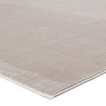 Close-up angled view showing soft lustrous pile and detailed edge stitching of rug