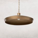 Eldon Pendant unlit hanging against neutral textured wall, visible hammered finish on shade