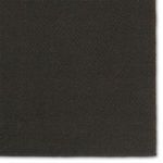 Edge close-up of Sena rug highlighting fine woven texture and dark brown binding