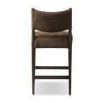 Rear view of Jayla counter stool emphasizing smooth leather back panel and tapered wood legs