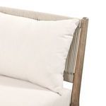 Angle detail of pillow edge and rounded wooden frame post