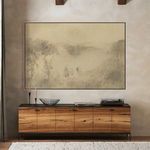 Along Side You painting hung above wooden sideboard in rustic room setting with light textured walls and exposed ceiling b...