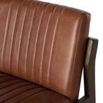 Close-up of vertical channel stitching on the brown leather seat cushion