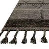 Close-up angled view showing detailed braided texture and knotted fringe of grey rug