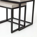 Close-up angled view of nested tables emphasizing square metal frames with matte black finish